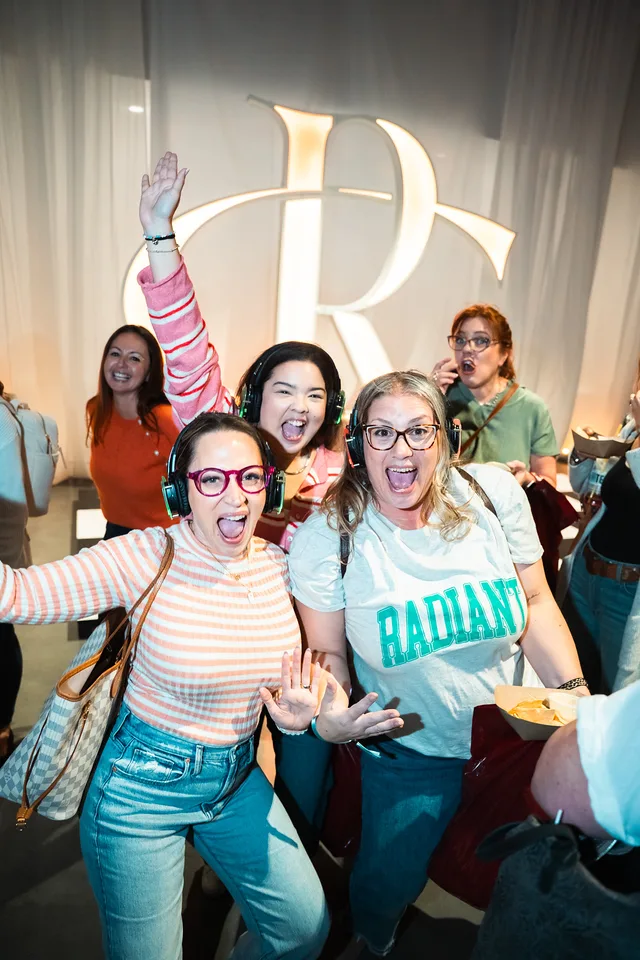 Three friends cheering at the women’s conference