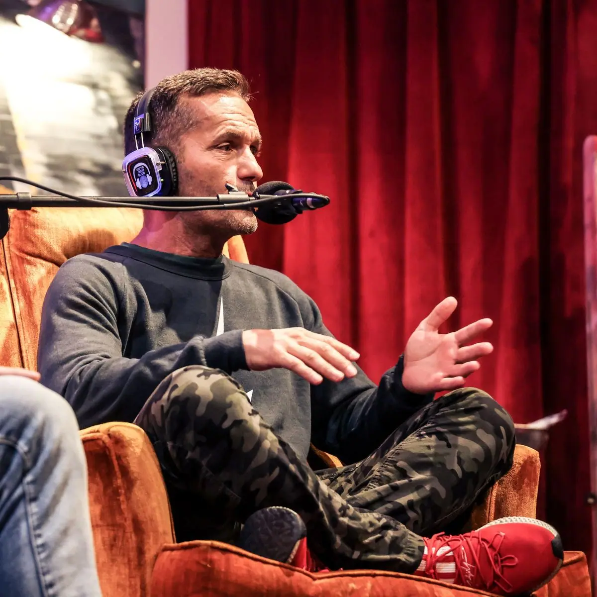 Speaker mid-story, headset mic and headphones on