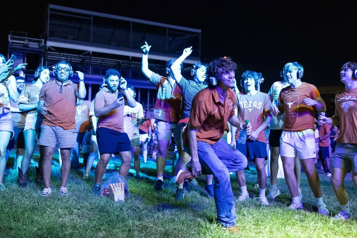 Students dancing on the lawn, headphones on — everyone controls their own volume