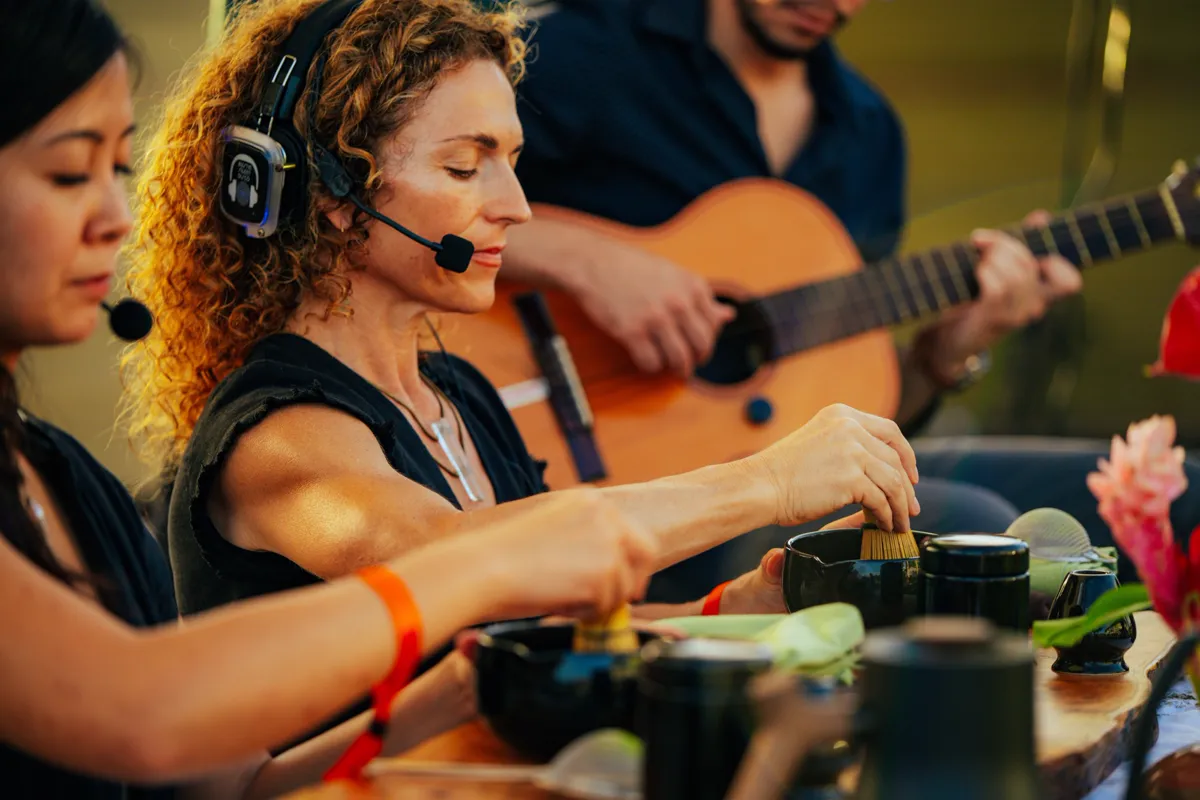 A tea ceremony with live music, headset mics and headphones on