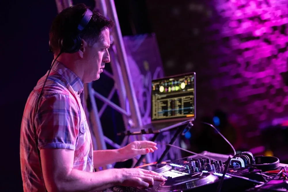 A second DJ working the controller beside the truss rig